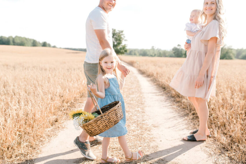 Family of four in pastel outfits during sunflower session at Davis Farm” / “Sunset sunflower family photography in Caledon